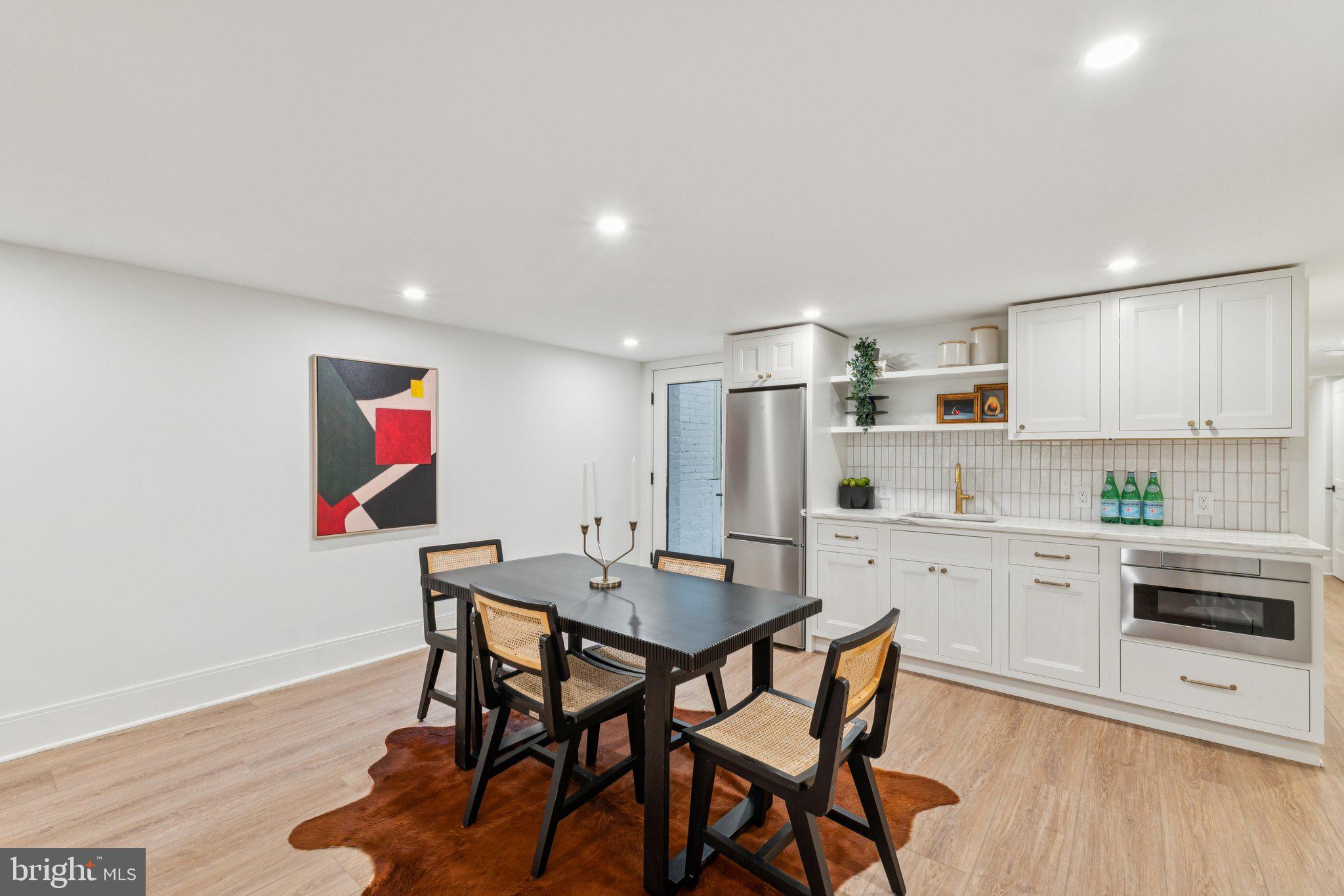 21 W Street Northwest Washington, DC 20001 - Photo 38 of 56 a kitchen with a dining table chairs and refrigerator
