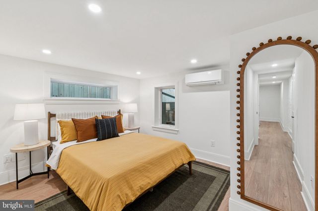 a bedroom with a bed and a lamp on table