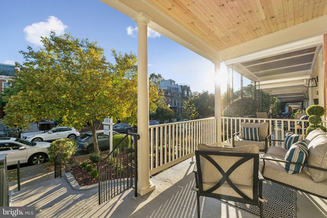 a view of a patio with table and chairs and wooden floor