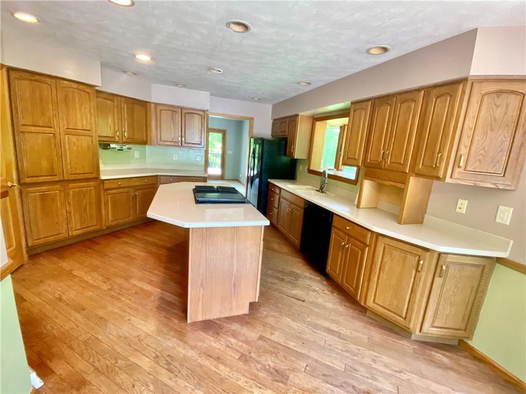 201 Curfew Road Perryopolis, PA 15473 - Photo 12 of 25 a kitchen with stainless steel appliances a sink stove and cabinets