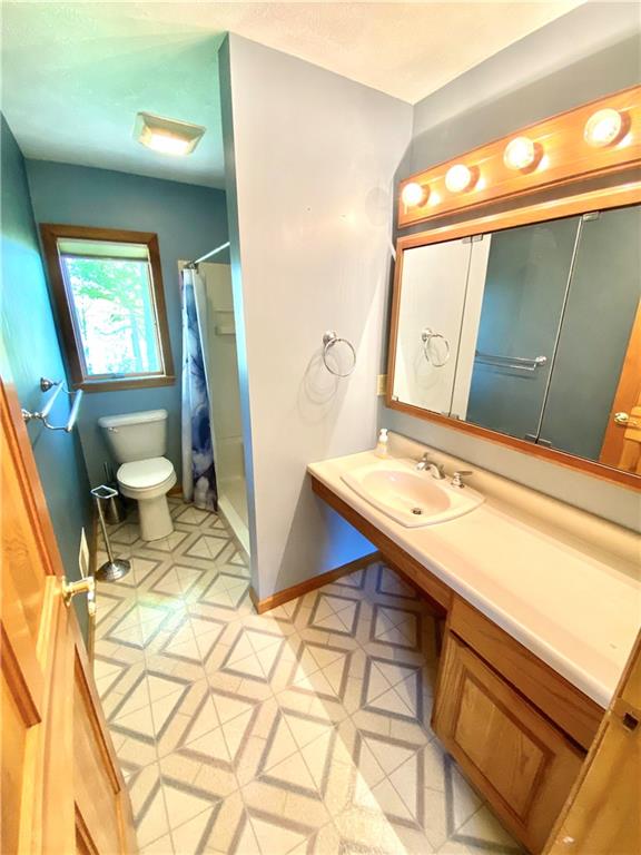 201 Curfew Road Perryopolis, PA 15473 - Photo 18 of 25 a bathroom with a sink a toilet and mirror
