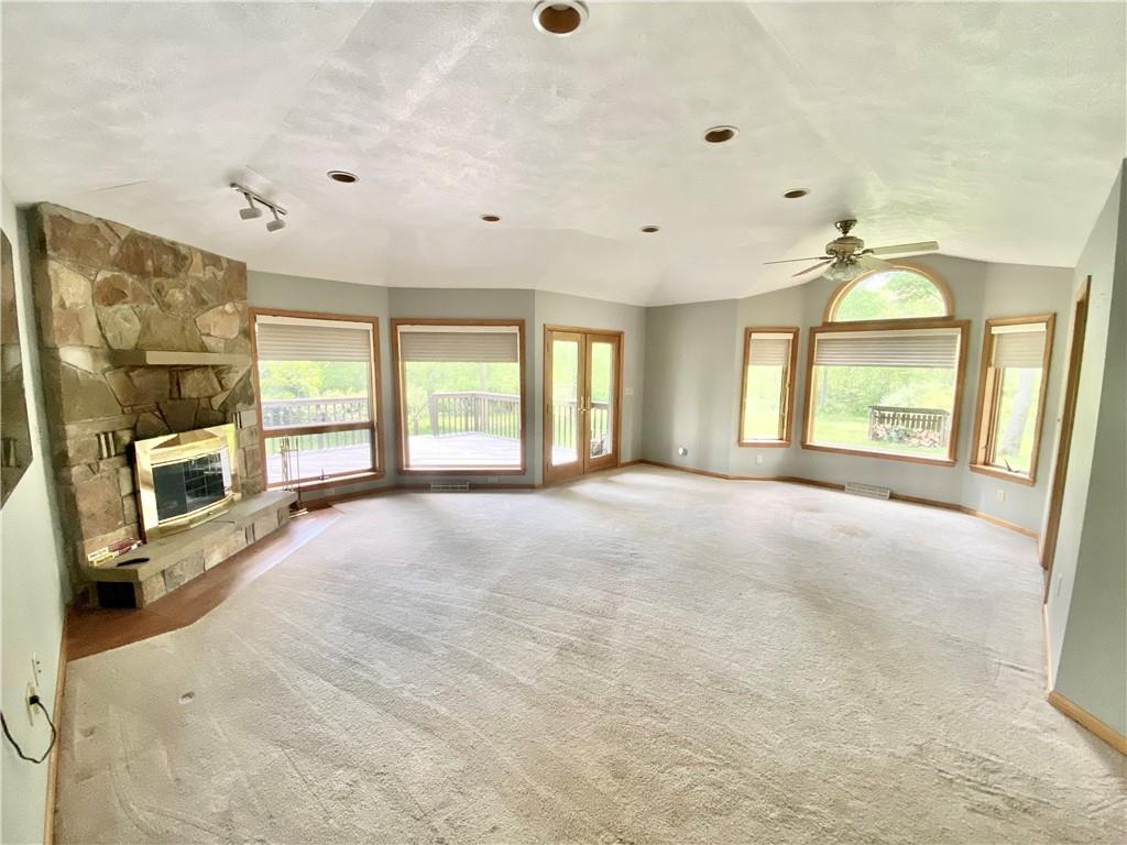 201 Curfew Road Perryopolis, PA 15473 - Photo 10 of 25 a view of an empty room with a fireplace and a large window
