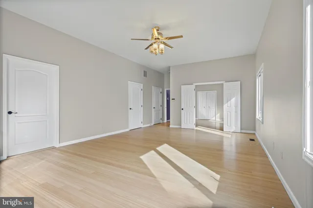 a view of an empty room and wooden floor
