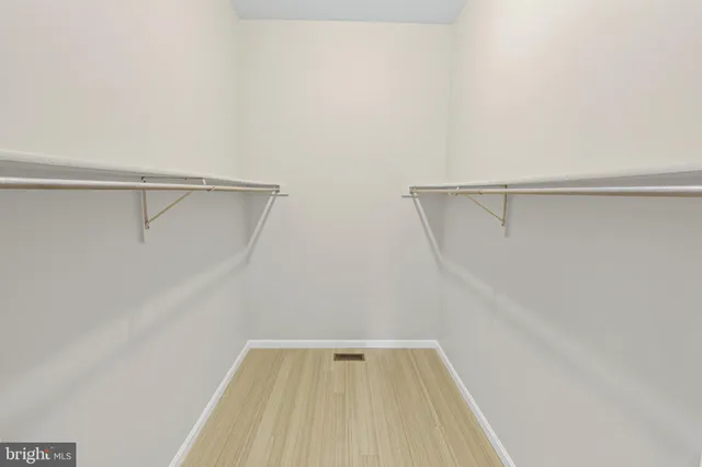 a utility room with stainless steel appliances a sink and a window