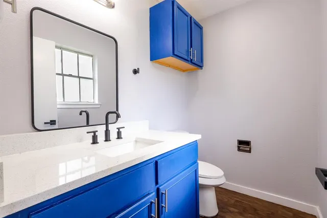 a bathroom with a toilet a sink and a mirror
