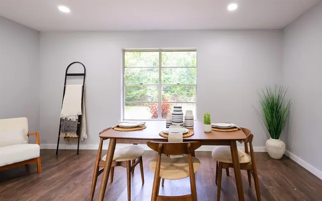 a view of a dining room with furniture and wooden floor