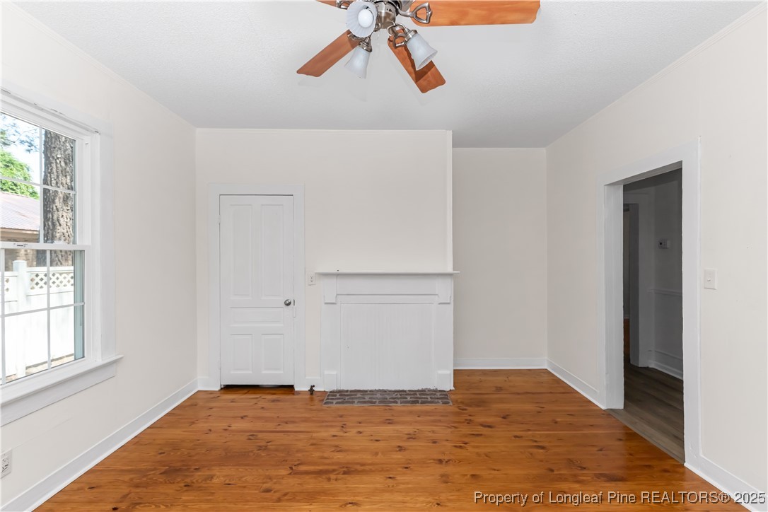 726 West M Street Erwin, NC 28339 - Photo 11 of 24 a view of empty room with window and wooden floor