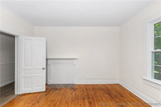 a view of a room with wooden floor