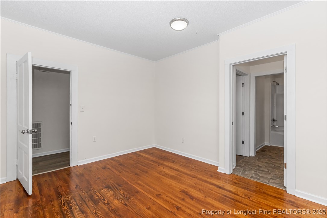 726 West M Street Erwin, NC 28339 - Photo 14 of 24 a view of a room with wooden floor and closet