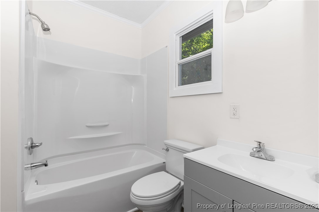 726 West M Street Erwin, NC 28339 - Photo 15 of 24 a bathroom with a toilet a sink and bathtub