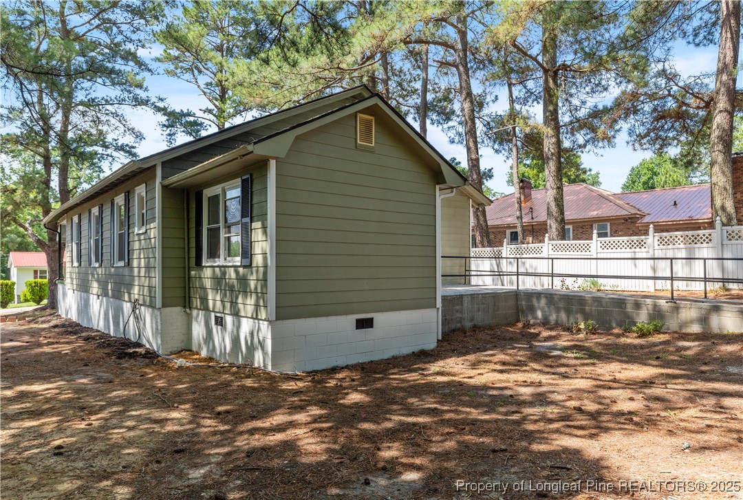 726 West M Street Erwin, NC 28339 - Photo 20 of 24 a front view of a house with a large tree
