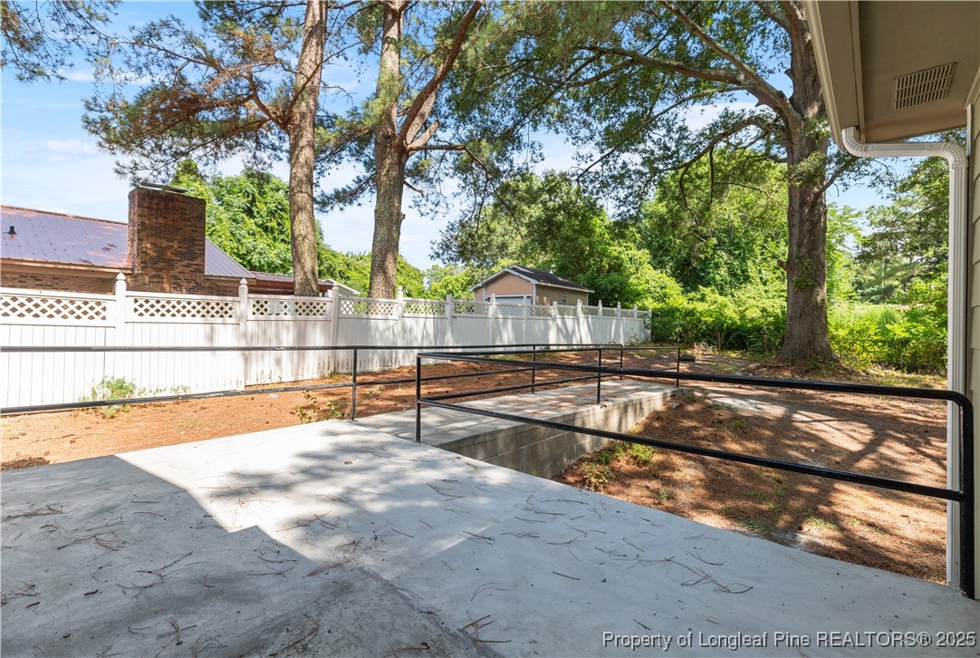726 West M Street Erwin, NC 28339 - Photo 22 of 24 a view of a yard with wooden fence