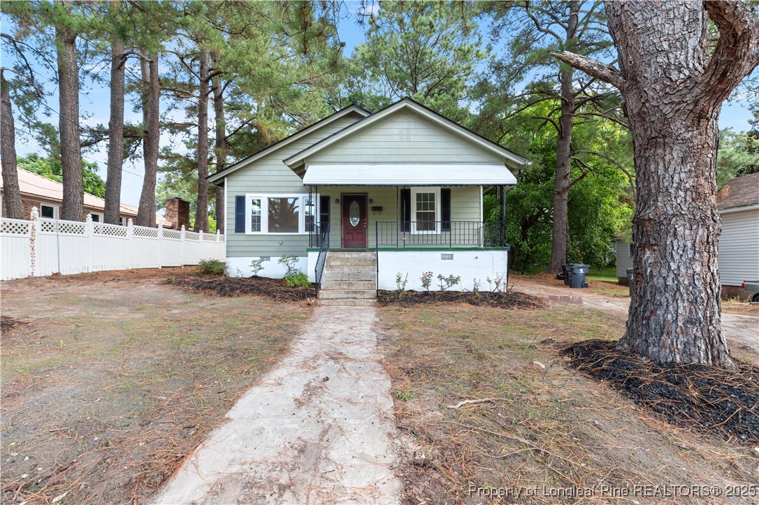 726 West M Street Erwin, NC 28339 - Photo 3 of 24 a front view of a house with a yard and garage