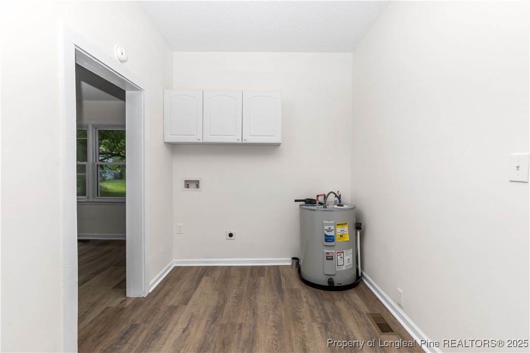 726 West M Street Erwin, NC 28339 - Photo 6 of 24 a view of an empty room with wooden floor and closet