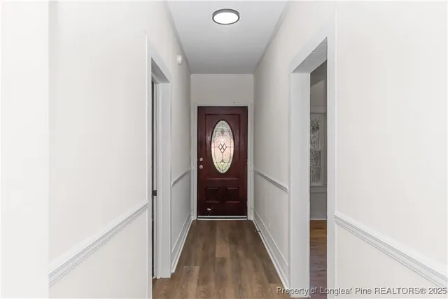 a view of hallway with wooden floor