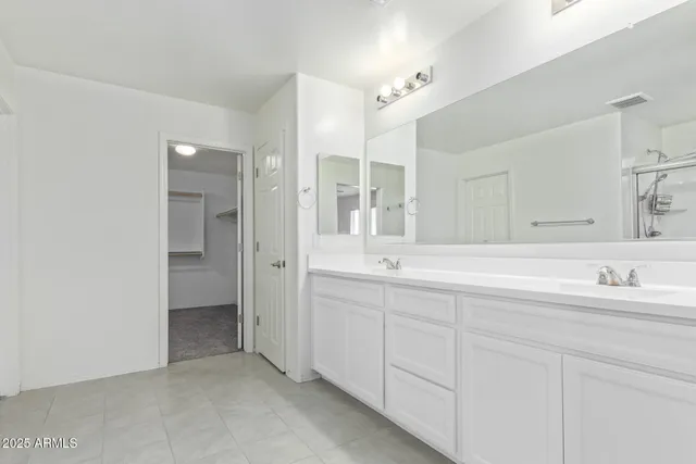 a view of a room with a ceiling fan and hardwood floor
