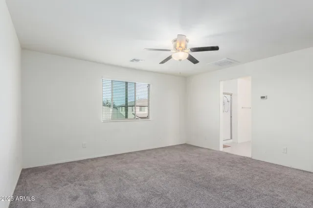 a view of a livingroom with a chandelier fan and entryway