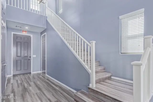 a view of entryway and hall with wooden floor