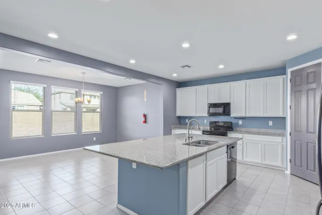 a kitchen with a sink stove and cabinets