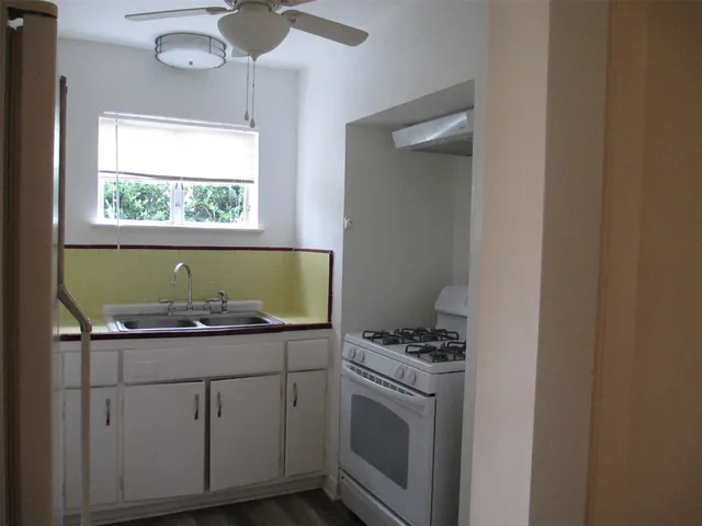 a kitchen with a sink and cabinets