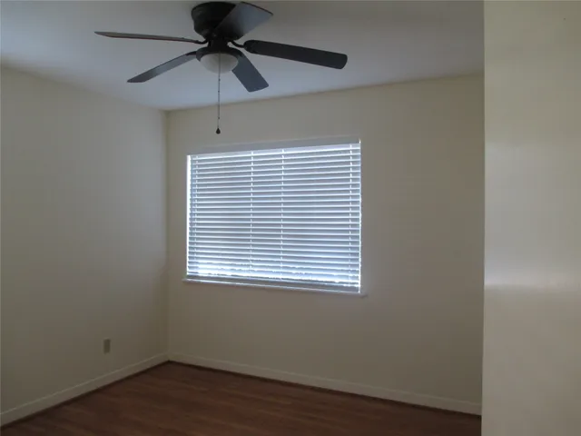 a view of a room with a window and wooden floor