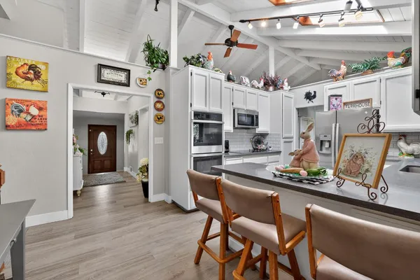 a dining room with furniture a rug and a large mirror