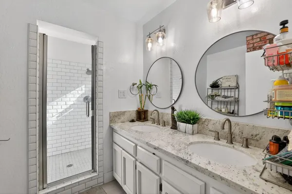 a kitchen with a sink a stove and white cabinets