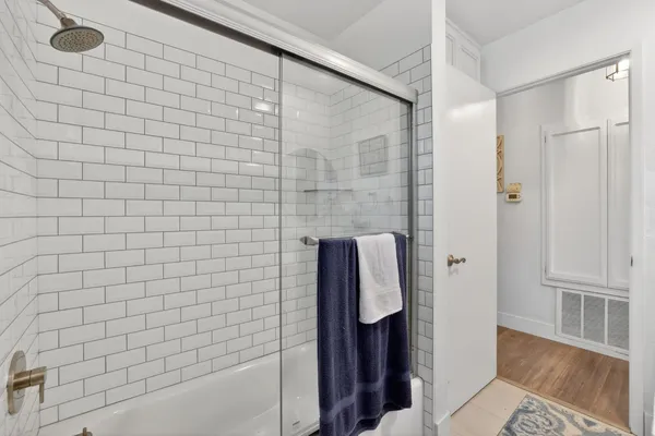 a bedroom with a bed and a flat tv screen on dresser