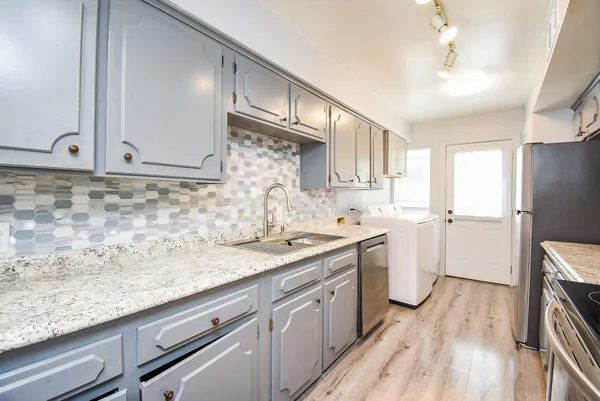 a kitchen with a sink stove and cabinets