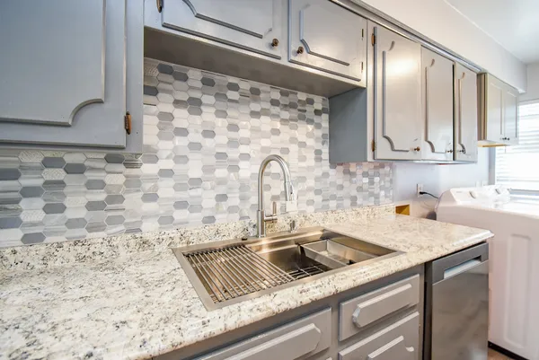 a kitchen with a sink and cabinets