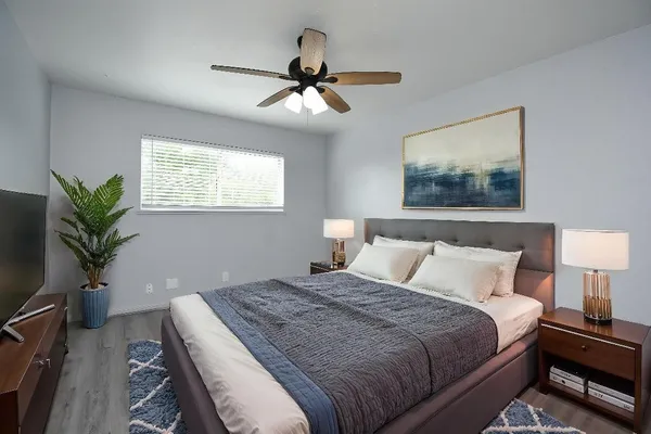 a bedroom with a bed and a potted plant