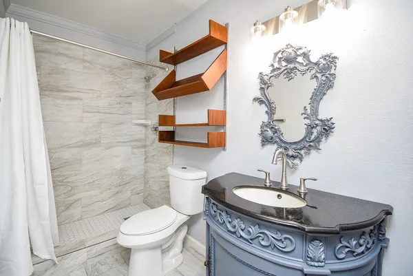 a dining room with a toilet and a mirror