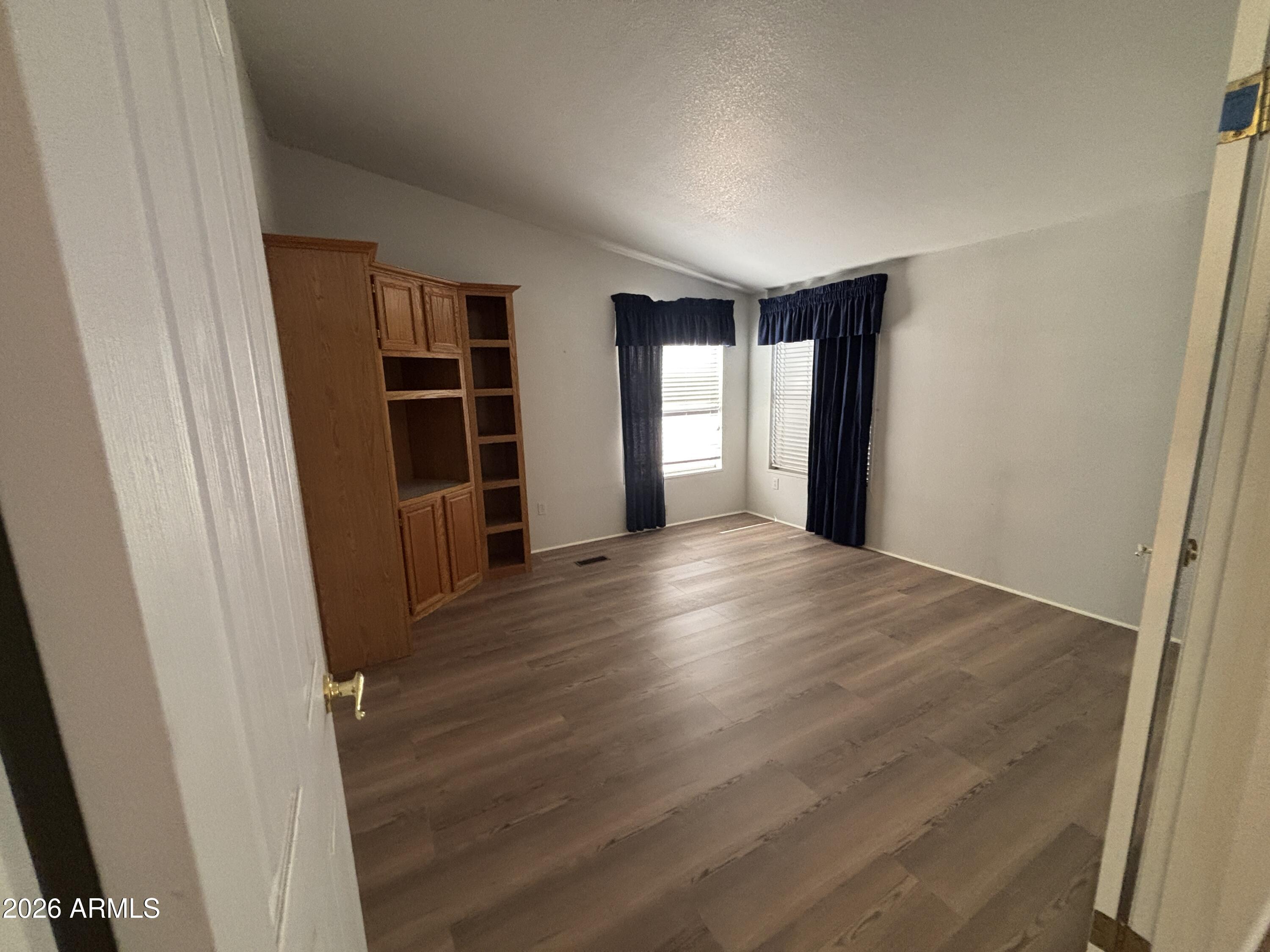3355 South Cortez Road, Unit 28 Apache Junction, AZ 85119 - Photo 15 of 24 an empty room with wooden floor and closet