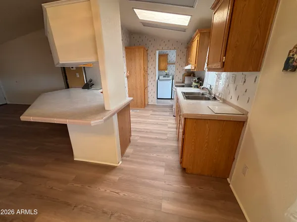 a kitchen with sink a refrigerator and cabinets