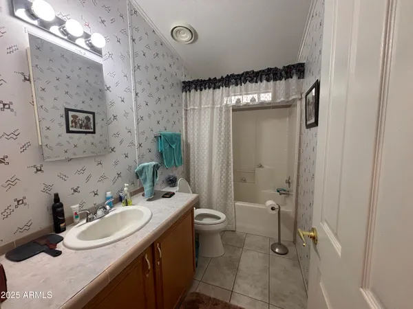 a bathroom with a sink a toilet a mirror and shower