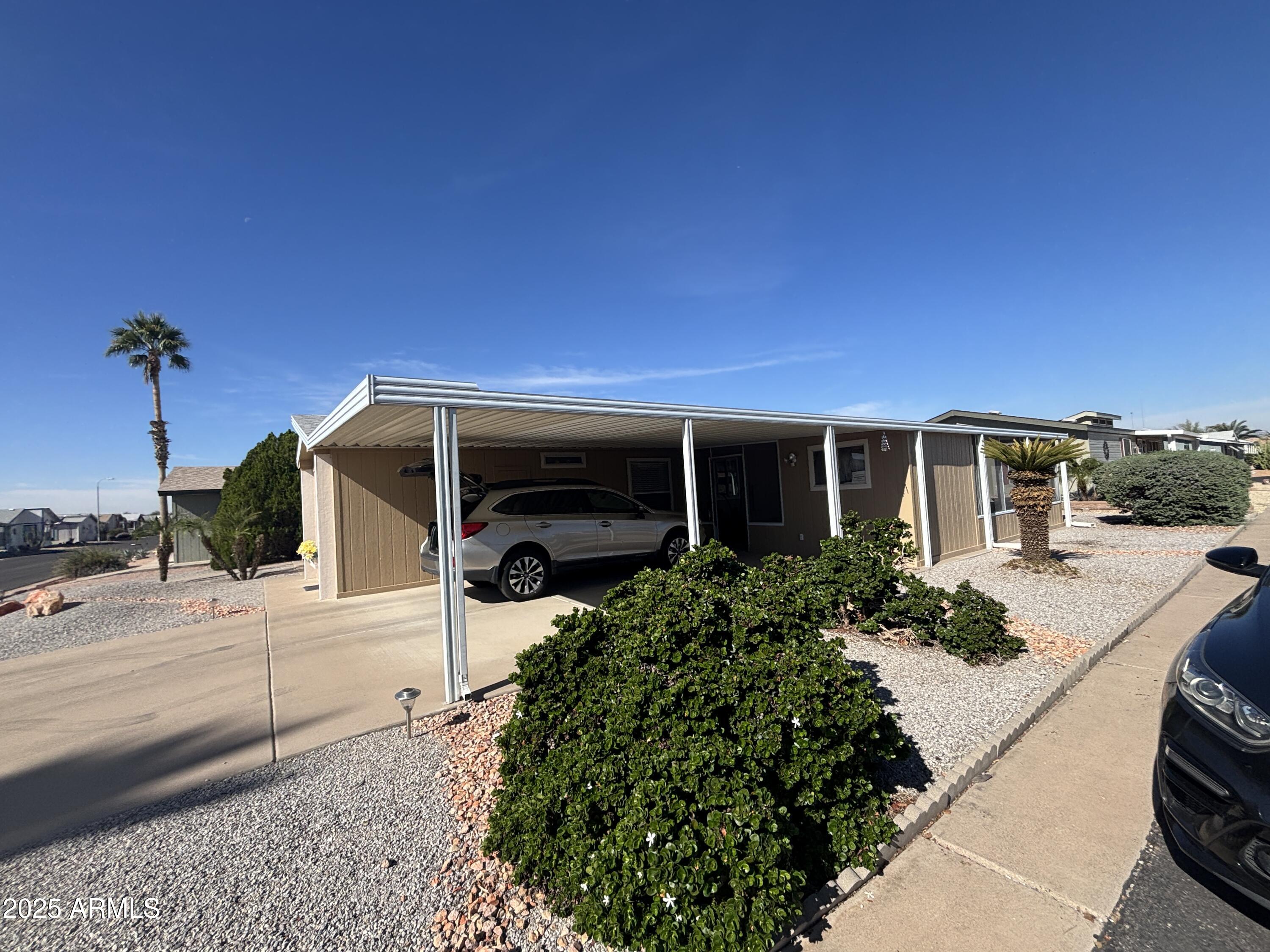 3355 South Cortez Road, Unit 28 Apache Junction, AZ 85119 - Photo 4 of 24 a front view of a house with garden