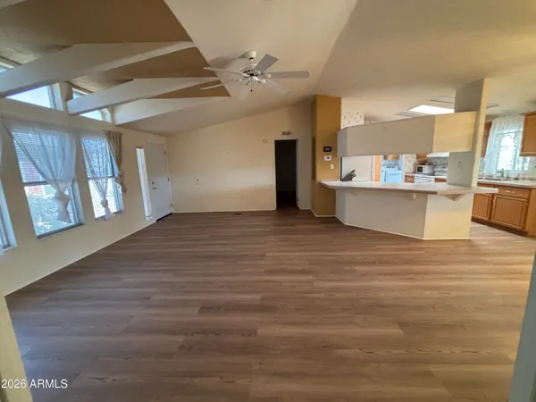 a view of a kitchen with wooden floor and a sink