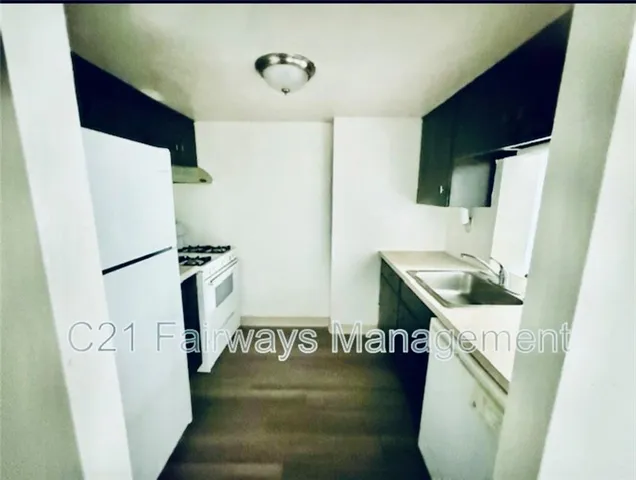 a bathroom with a sink toilet and a mirror