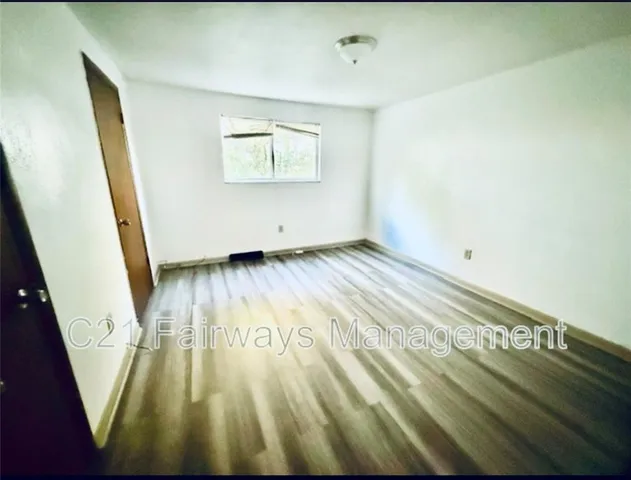 a view of wooden floor in an empty room