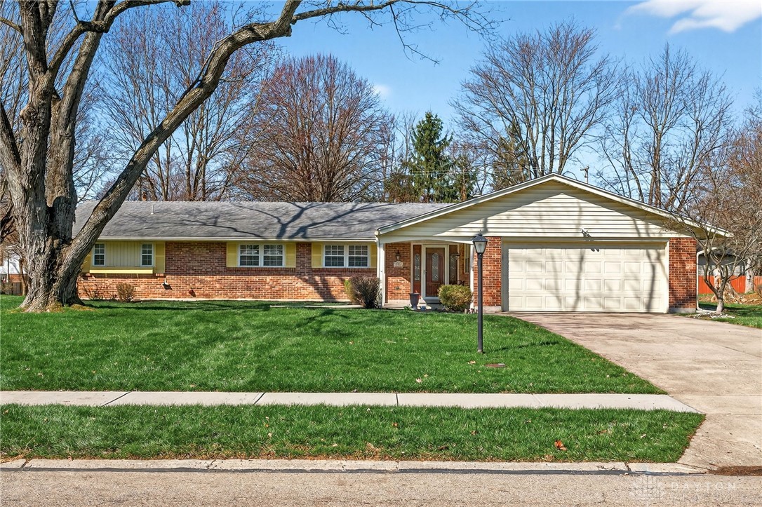 5907 Red Coach Road Dayton, OH 45429 - Photo 3 of 50 This charming residence features a brick exterior and an inviting front yard with mature trees.