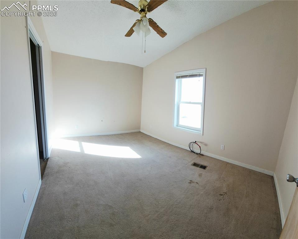 6760 Yoder Road Yoder, CO 80864 - Photo 15 of 23 an empty room with windows and fan view