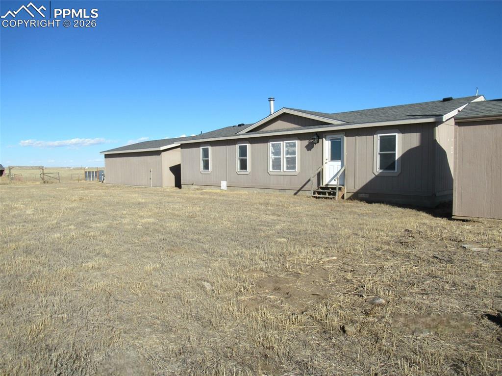 6760 Yoder Road Yoder, CO 80864 - Photo 2 of 23 a front view of a house with a yard