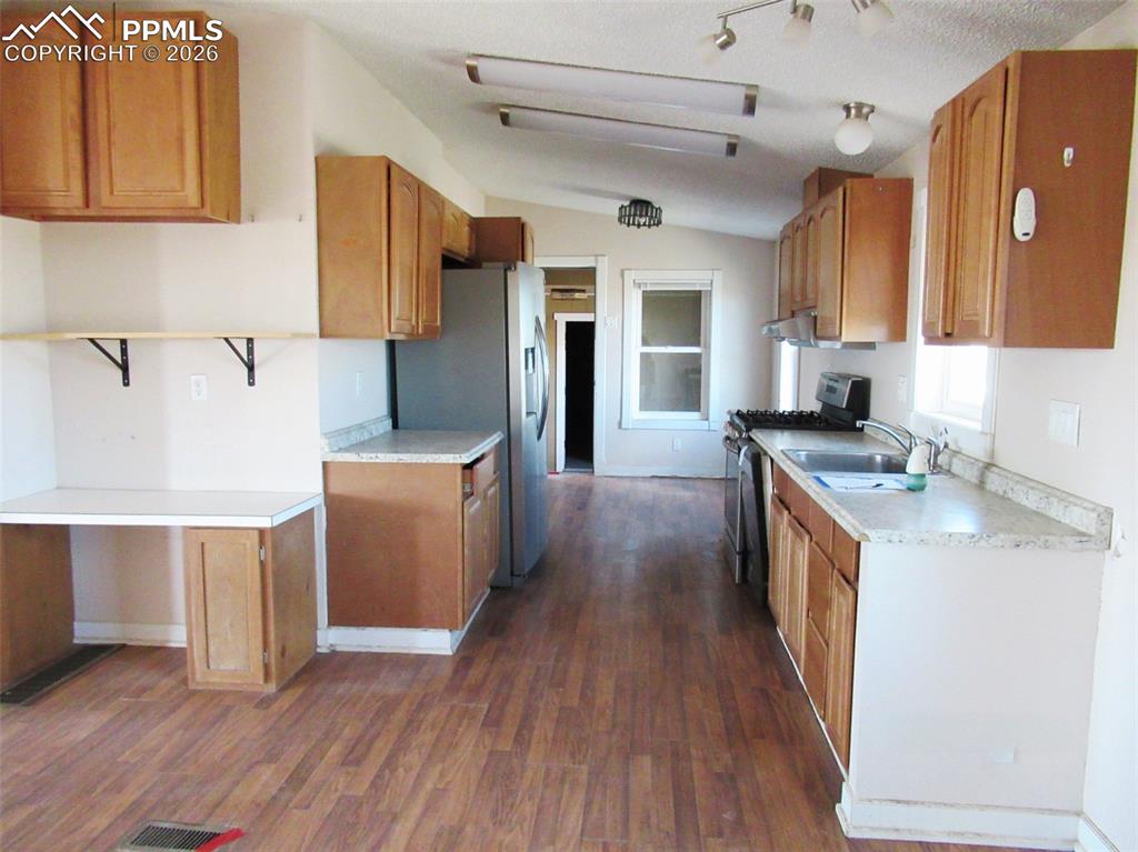 6760 Yoder Road Yoder, CO 80864 - Photo 6 of 23 a kitchen with stainless steel appliances granite countertop a sink a stove a refrigerator and cabinets