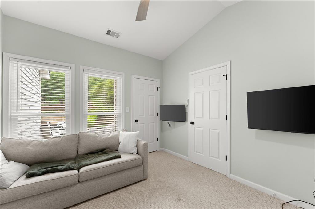 2300 Habersham Marina Road, Unit 302 Cumming, GA 30041 - Photo 24 of 31 a living room with furniture and a flat screen tv