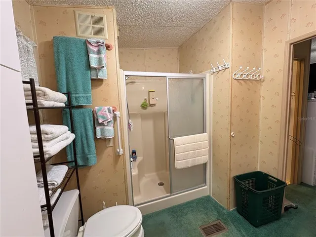 a bathroom with a toilet and a shower