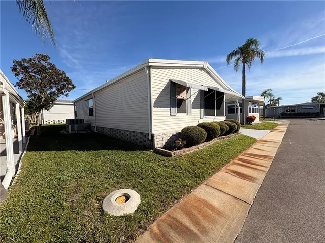 a view of a house with backyard and sitting area