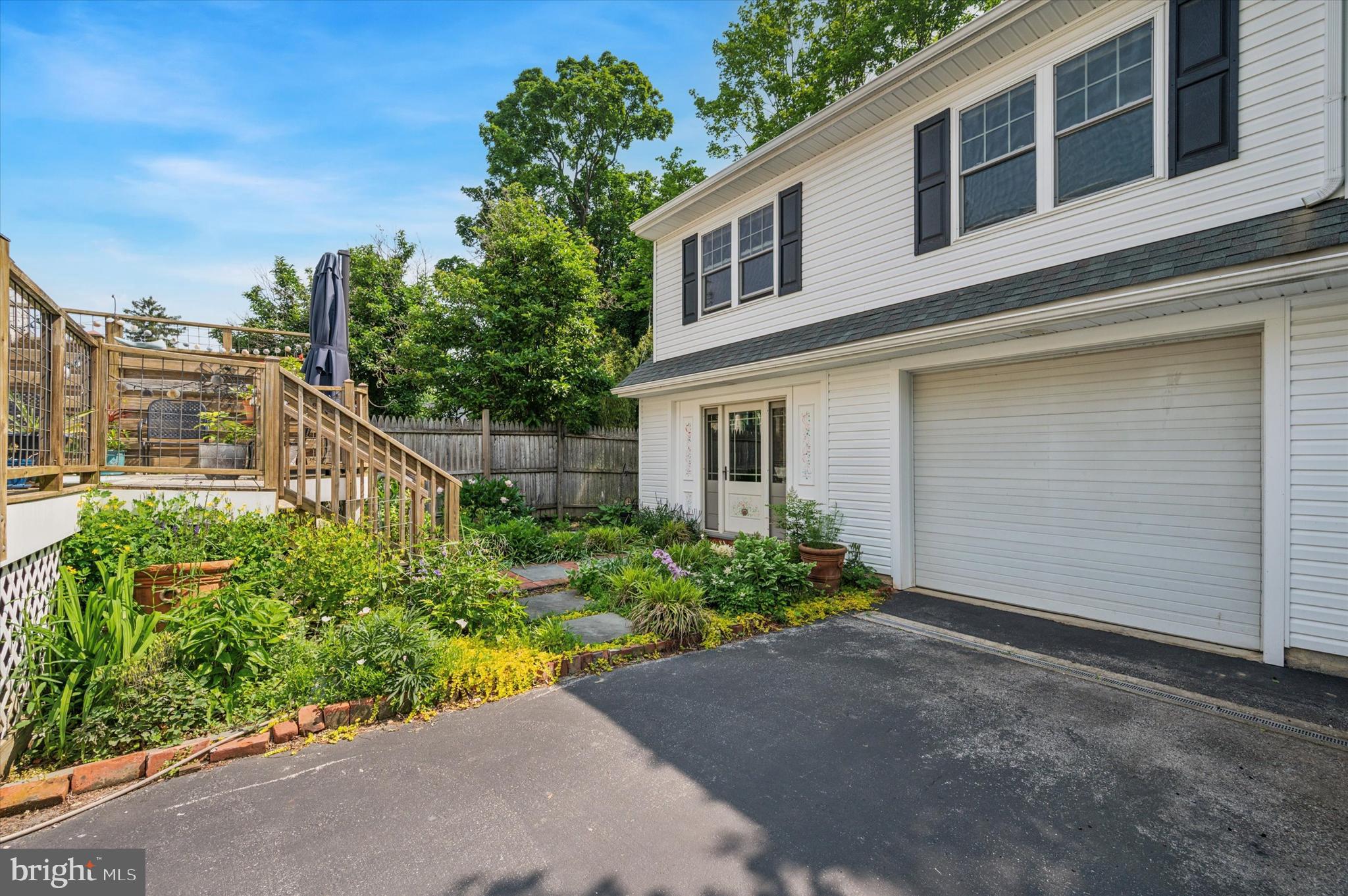 119 Francis Avenue Wayne, PA 19087 - Photo 25 of 26 a house with a flower garden in front of it