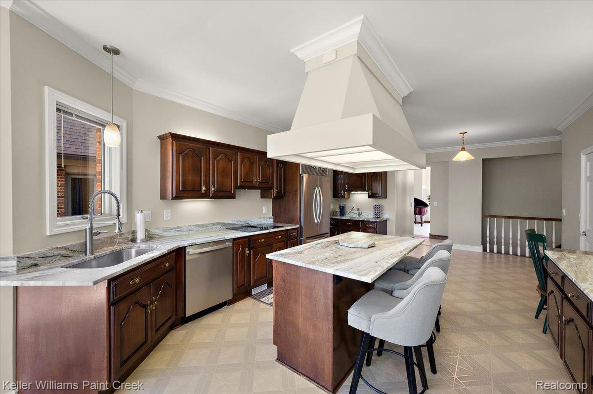 69069 Campground Road Romeo, MI 48065 - Photo 34 of 78 Spacious kitchen featuring dark wood cabinetry, light-toned countertops, and stainless steel appliances
