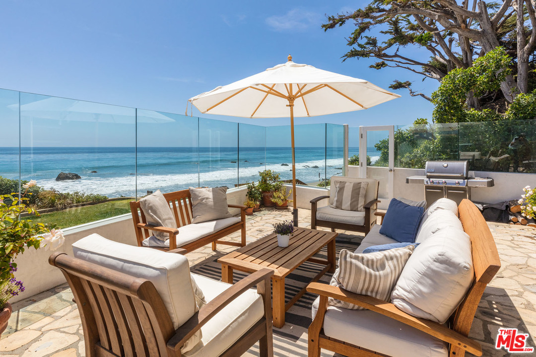 31725 Sea Level Drive Malibu, CA 90265 - Photo 1 of 37 a view of a patio with couches under an umbrella