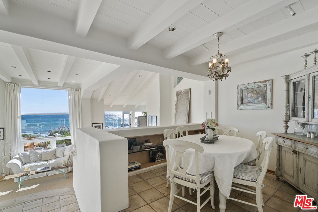 31725 Sea Level Drive Malibu, CA 90265 - Photo 12 of 37 a view of a dining room with furniture and a chandelier